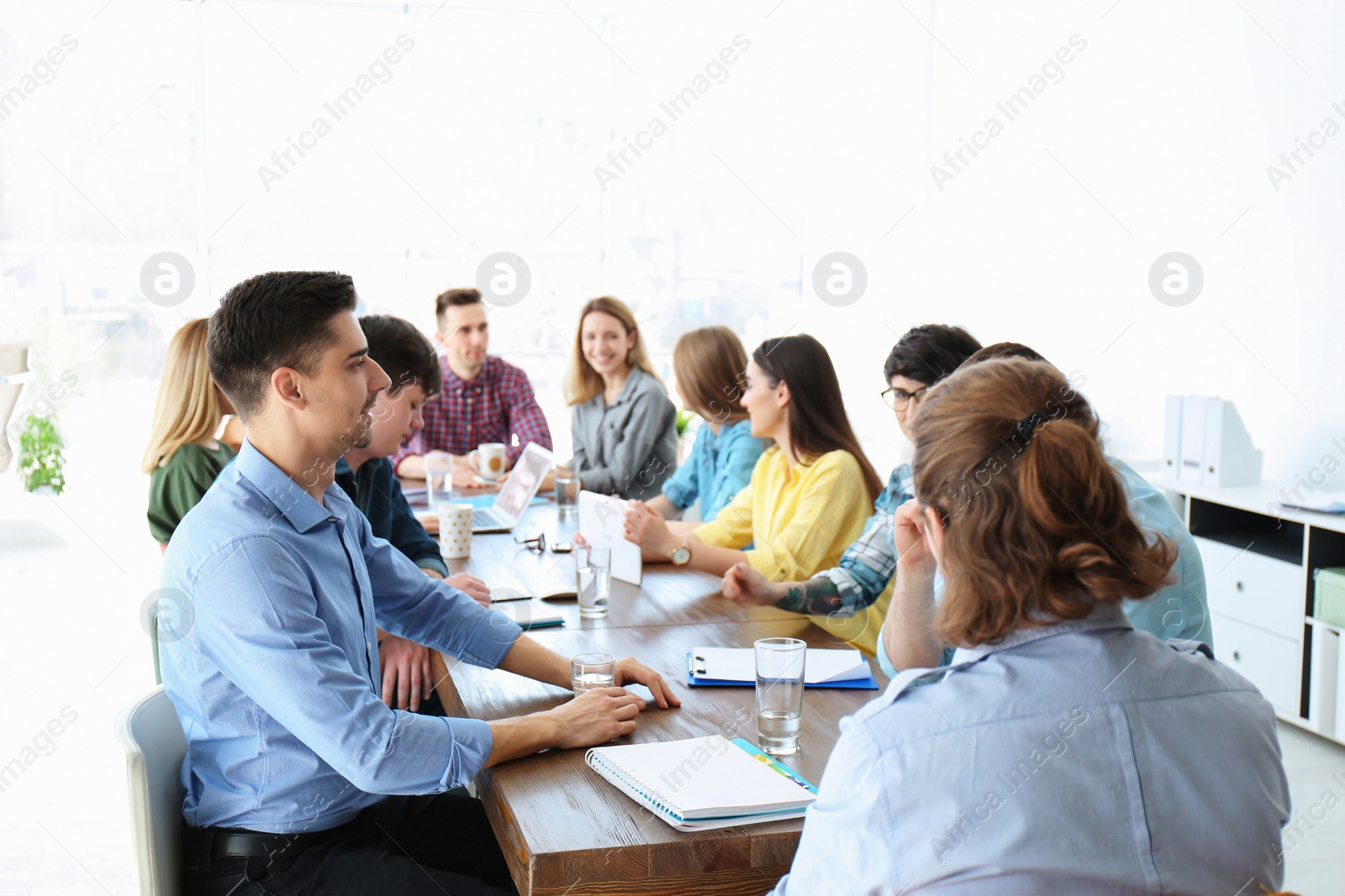 Photo of Young people having business training in office