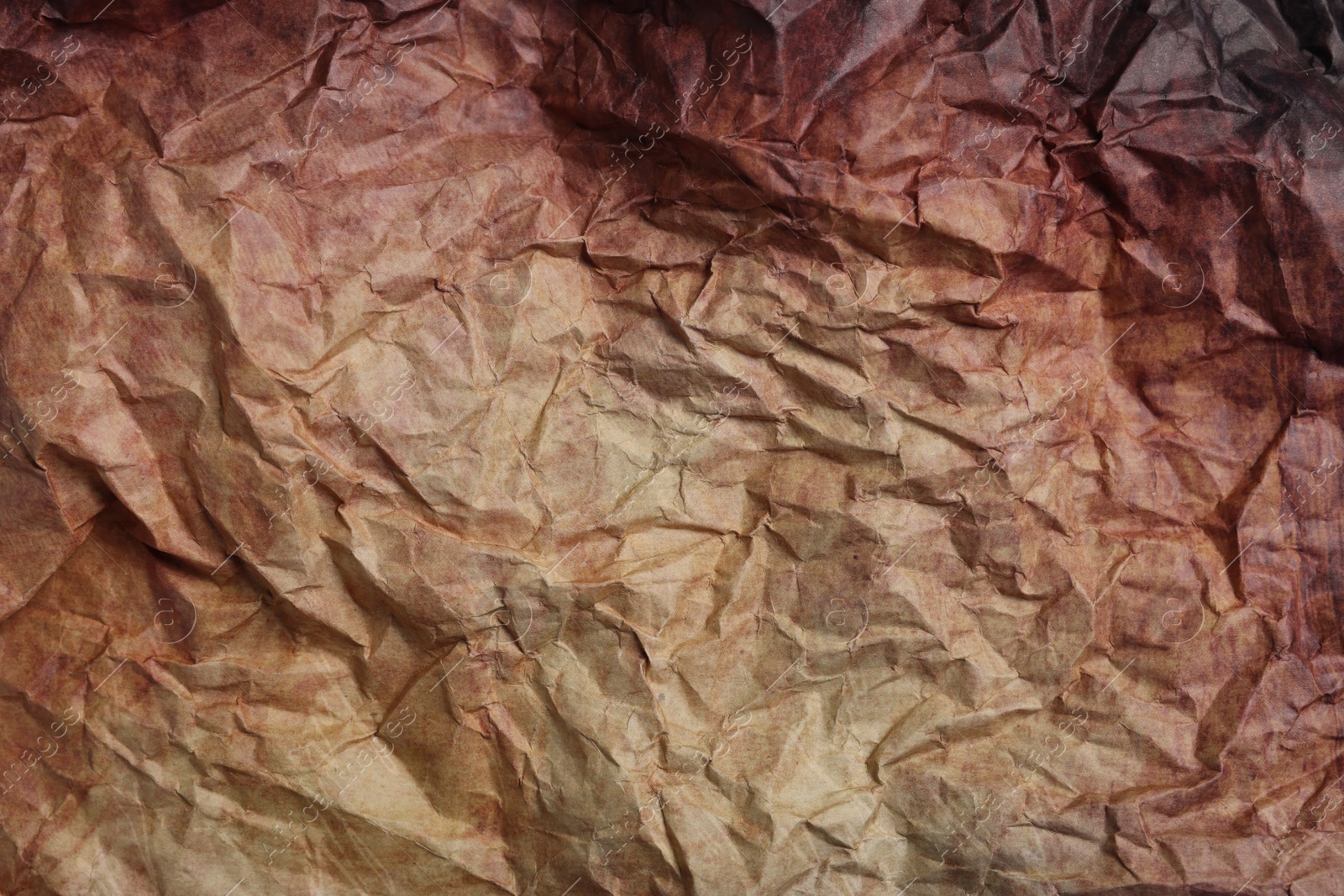 Photo of Texture of crumpled parchment paper as background, top view