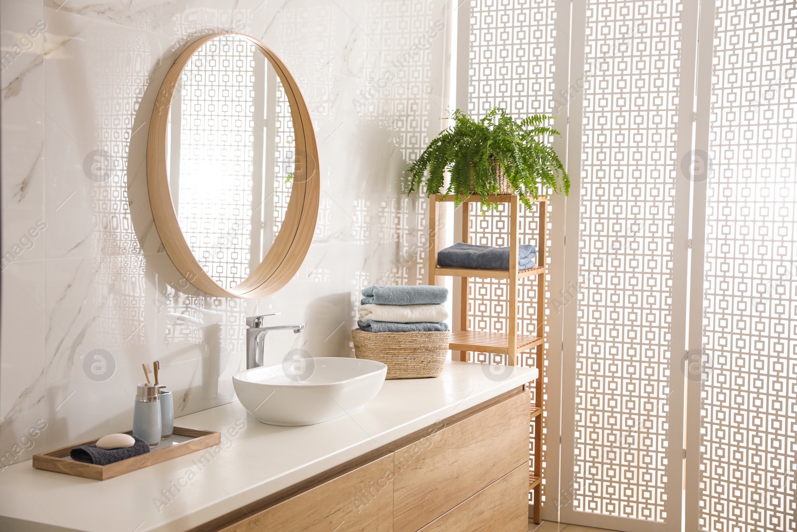 Photo of Stylish bathroom interior with mirror and countertop. Design idea