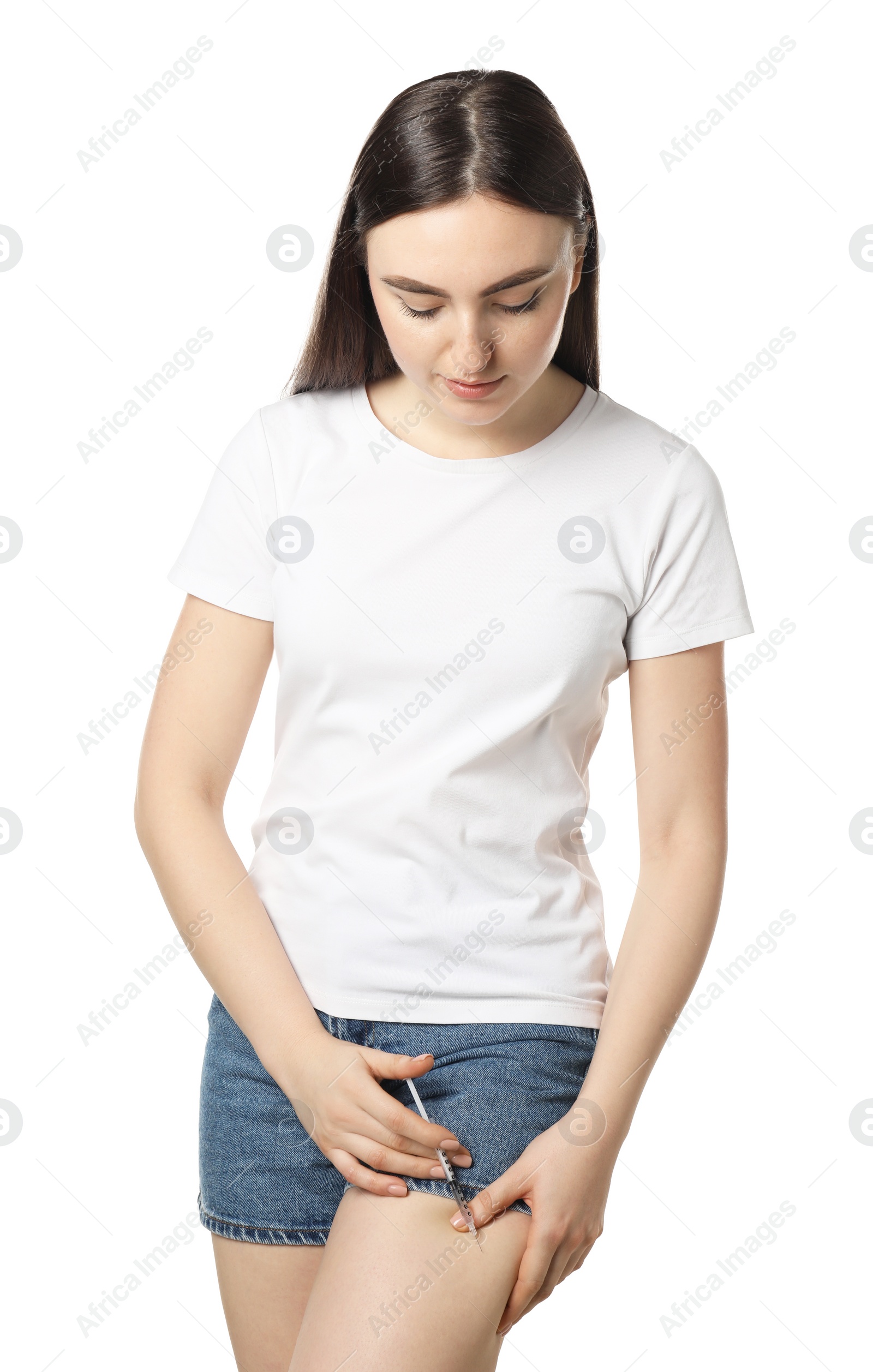 Photo of Diabetes. Woman making insulin injection into her leg on white background