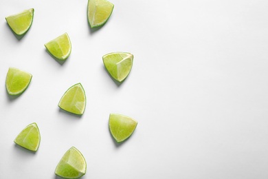 Composition with fresh ripe limes on white background, top view