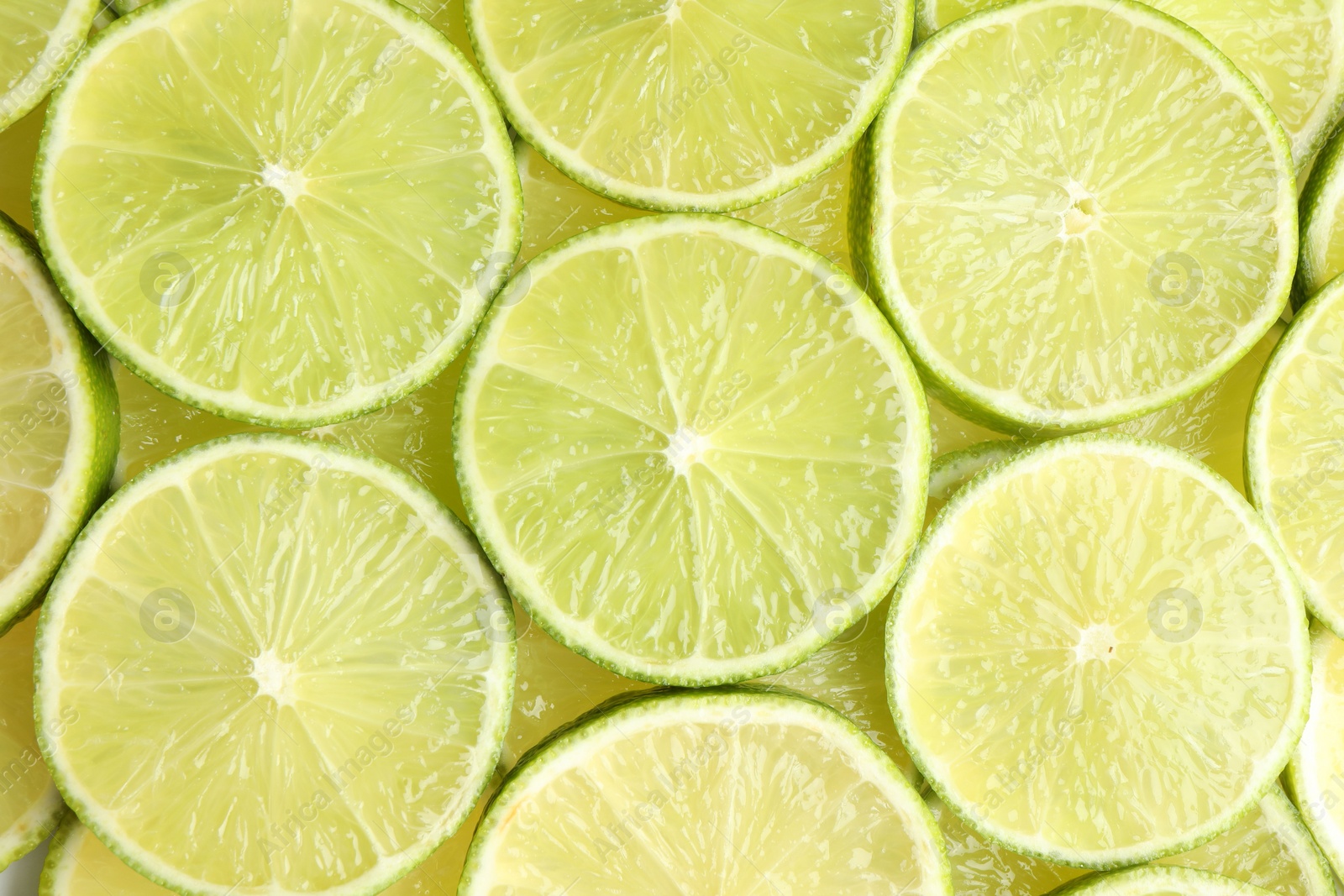 Photo of Fresh juicy lime slices as background, top view