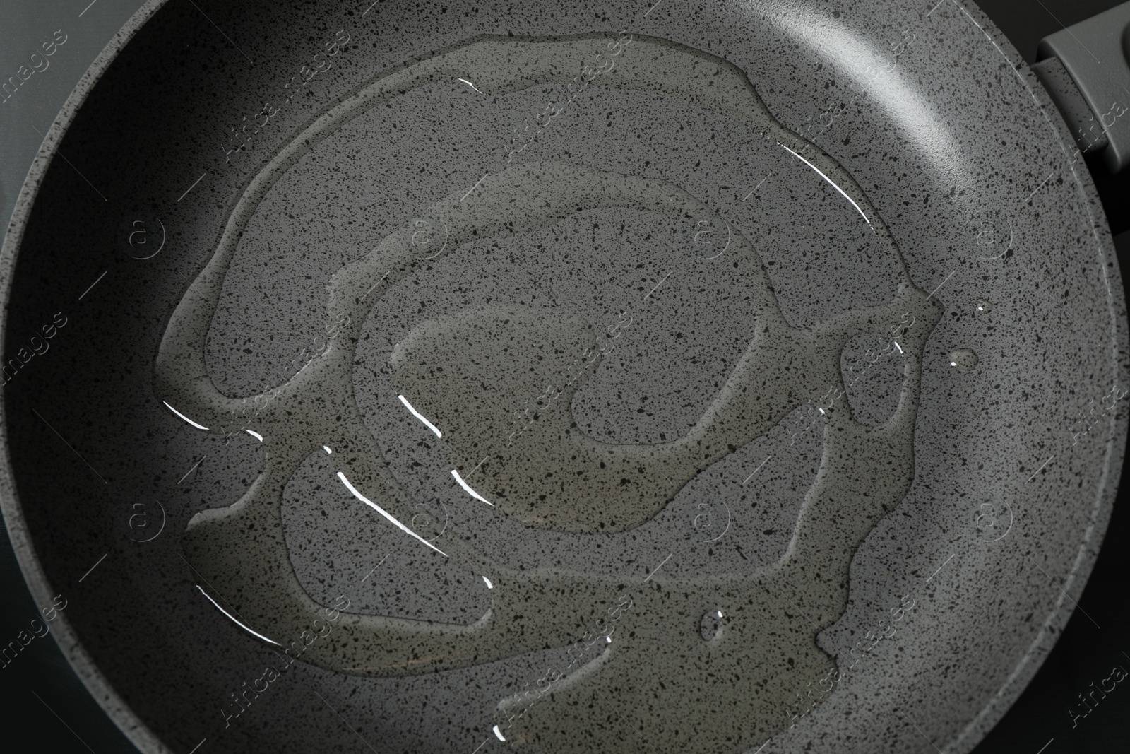 Photo of Cooking oil in frying pan, top view