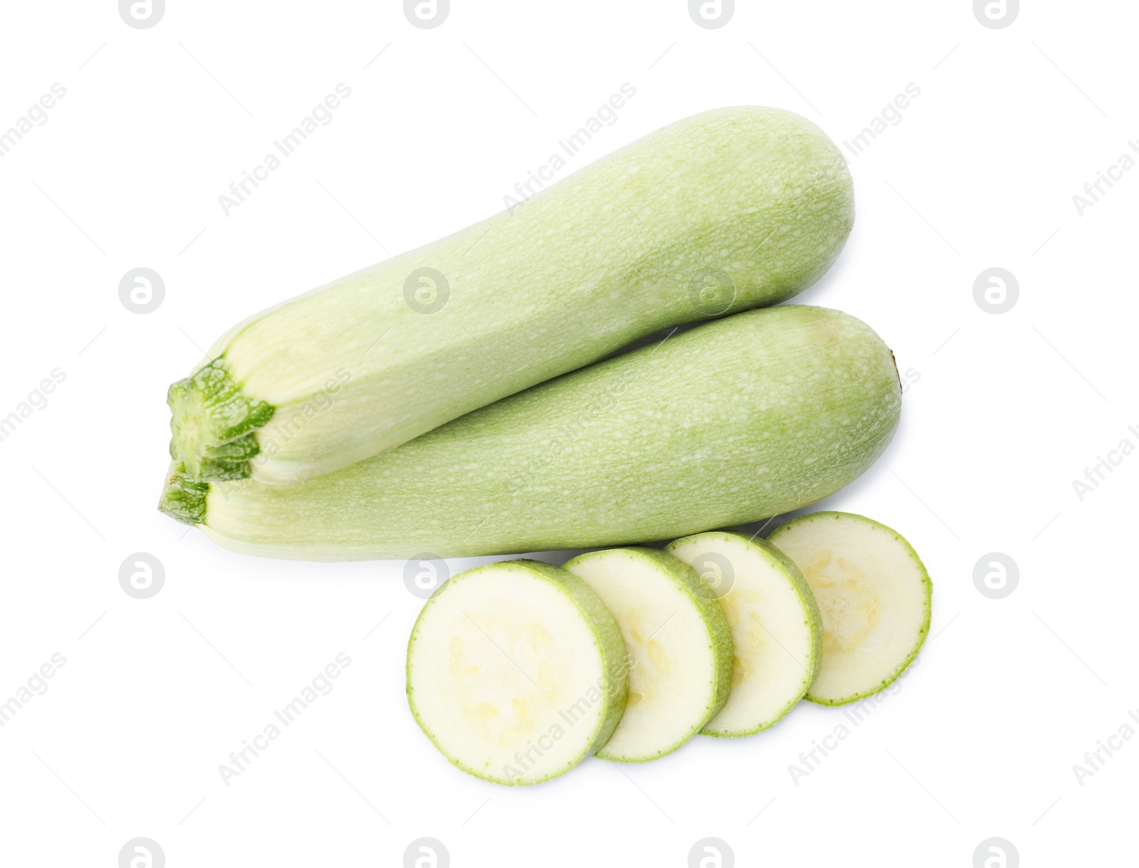 Photo of Cut and whole green ripe zucchinis on white background, top view