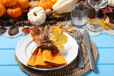 Photo of Happy Thanksgiving day. Beautiful table setting with autumn decor on light blue wooden background