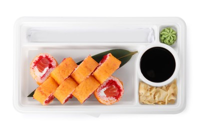 Food delivery. Delicious sushi rolls with soy sauce, ginger, wasabi and chopsticks in plastic container isolated on white, top view