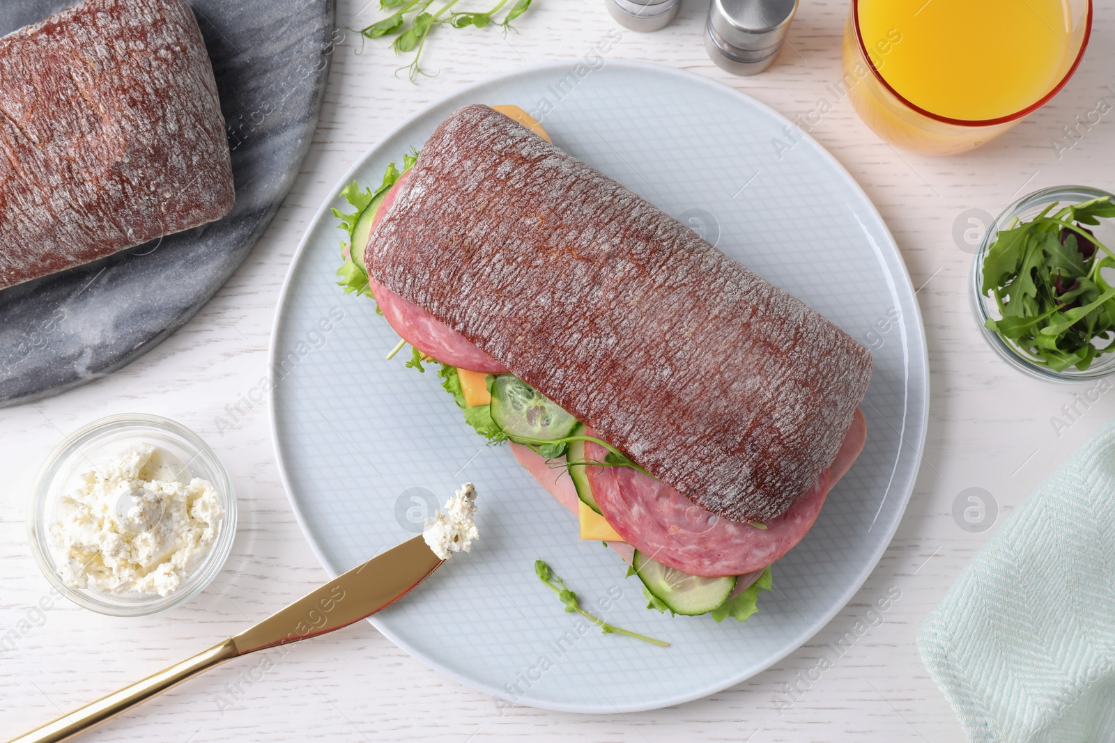 Photo of Tasty sandwich with ham served on white wooden table, flat lay