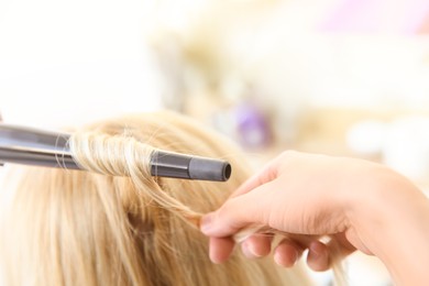 Image of Professional hairdresser working with client in salon