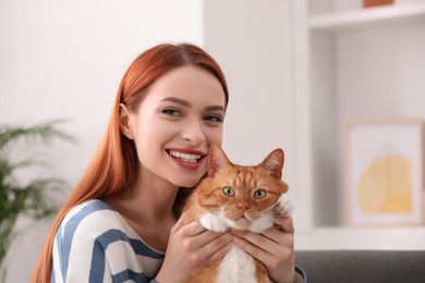 Happy woman with her cute cat at home