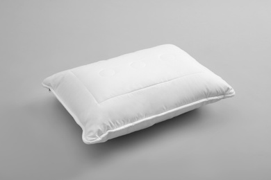 Photo of Clean soft bed pillow on grey background