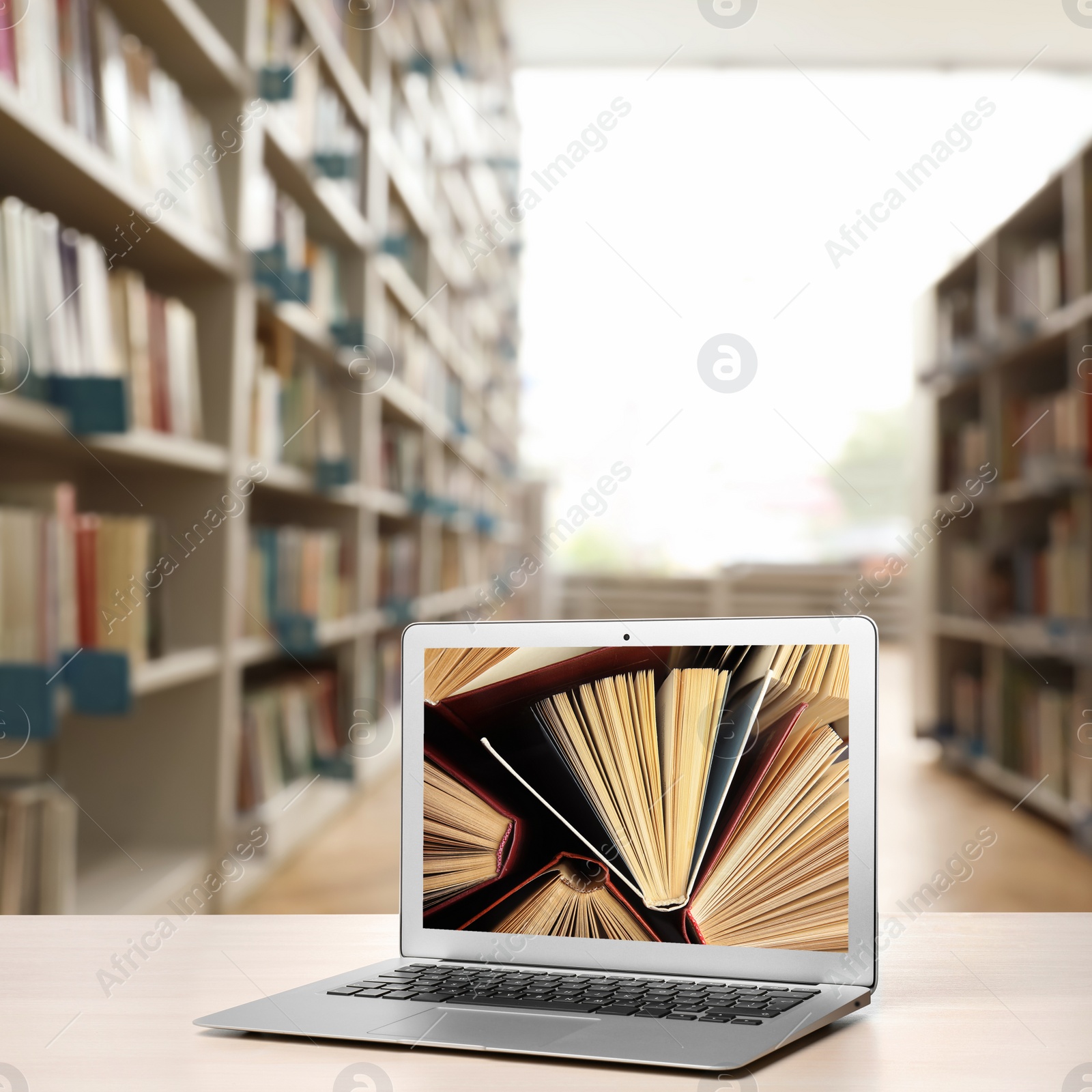 Image of Digital library concept. Modern laptop on table indoors