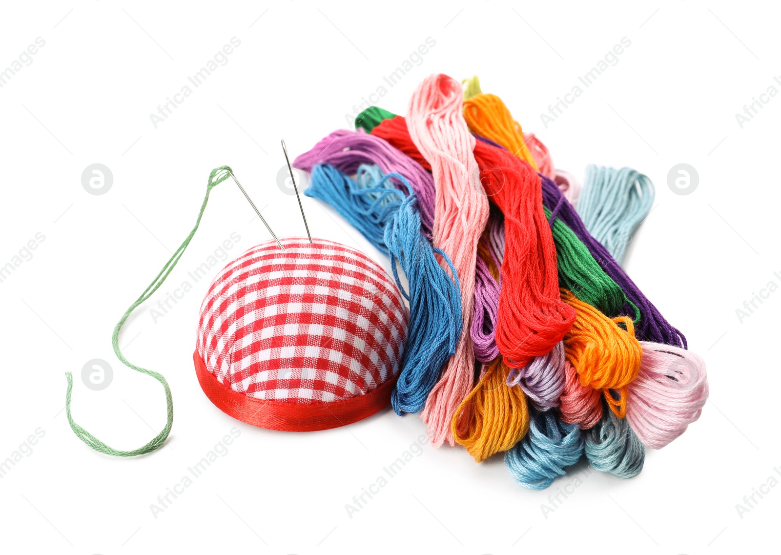 Photo of Colorful embroidery floss set and needle cushion on white background