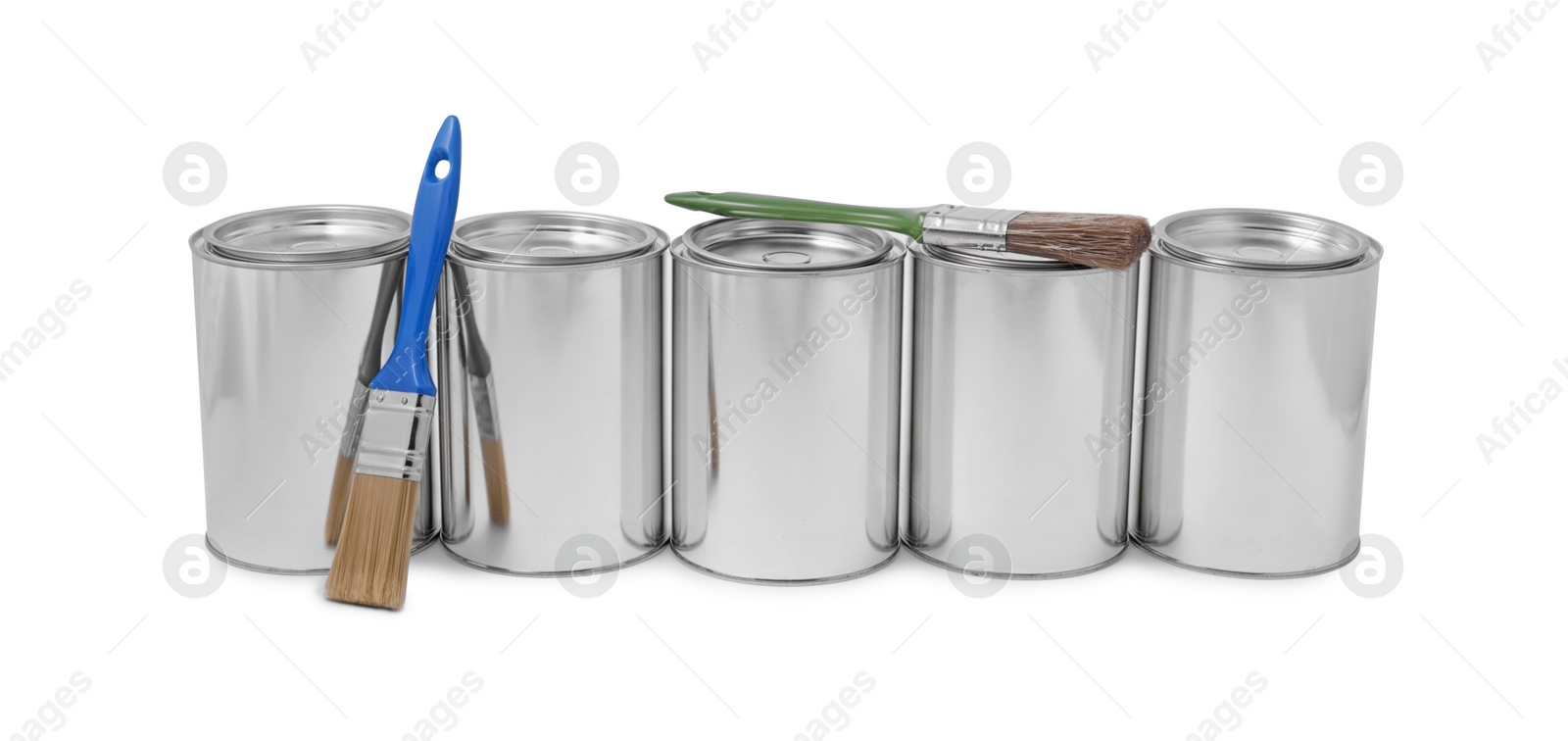 Photo of Cans of paints and brush on white background