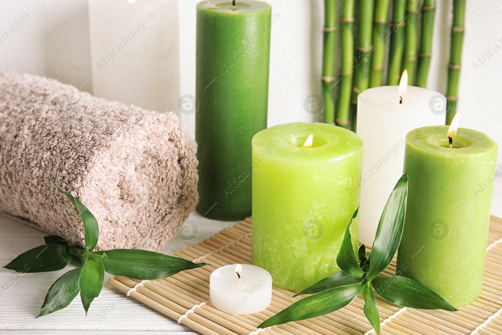 Photo of Beautiful spa composition with green candles on table