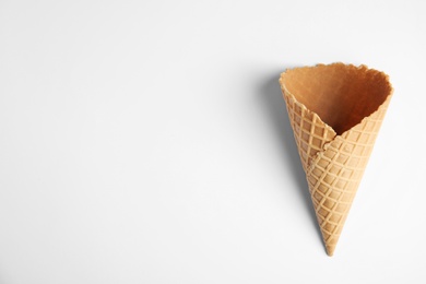 Empty wafer ice cream cone on white background, top view