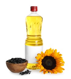Sunflower cooking oil, seeds and yellow flower on white background
