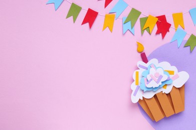 Photo of Birthday party. Colorful bunting flags and paper cupcake on pink background, flat lay. Space for text
