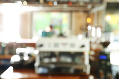 Photo of Blurred view of coffee machine on bar counter in cafe
