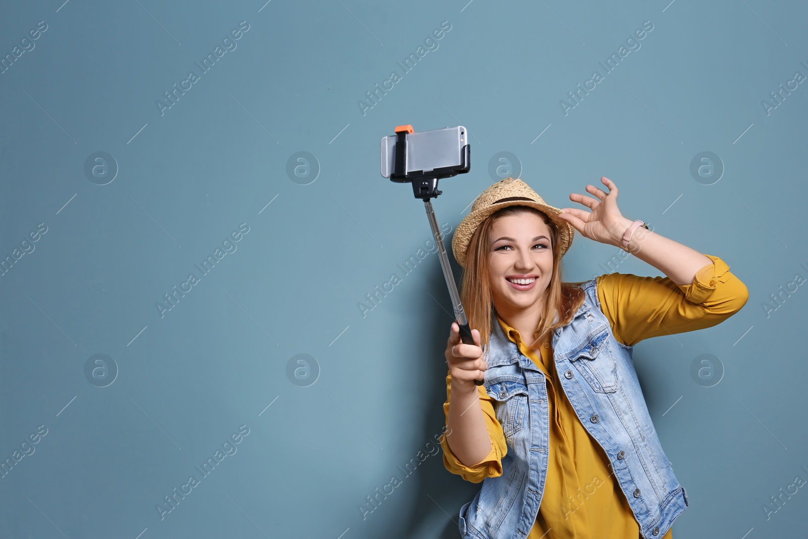 Photo of Attractive young woman taking selfie on color background