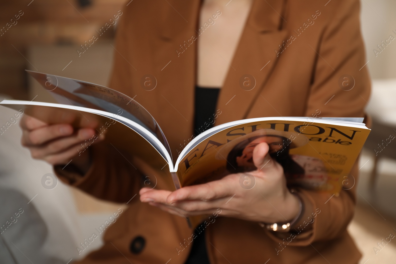 Photo of Woman reading fashion magazine at home, closeup