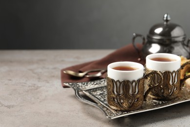 Photo of Tea served in vintage tea set on grey table, space for text