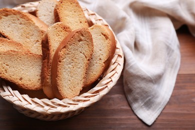 Photo of Hard chuck crackers in wicker basket on wooden table