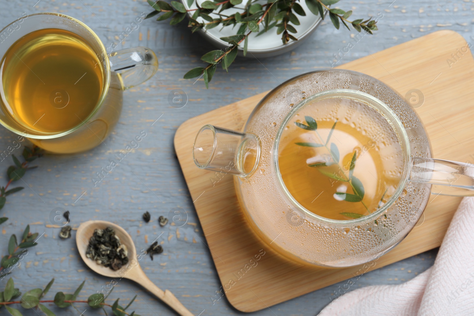 Photo of Aromatic eucalyptus tea on grey wooden table, flat lay