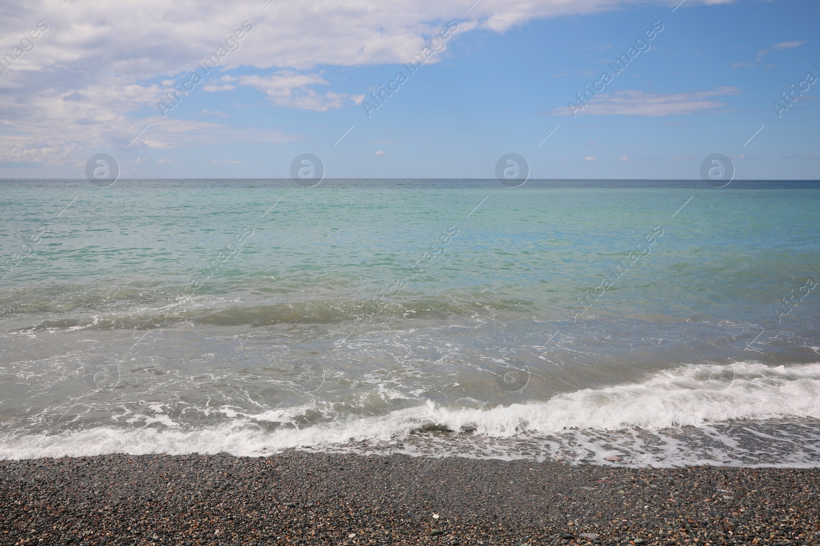 Photo of Picturesque view of beautiful sea shore under sky with clouds