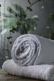 Photo of White terry towels on table in bathroom