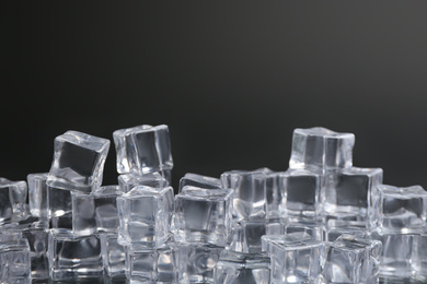 Photo of Crystal clear ice cubes on black background