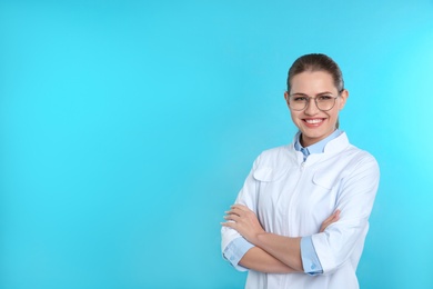 Photo of Portrait of female dentist on color background. Space for text