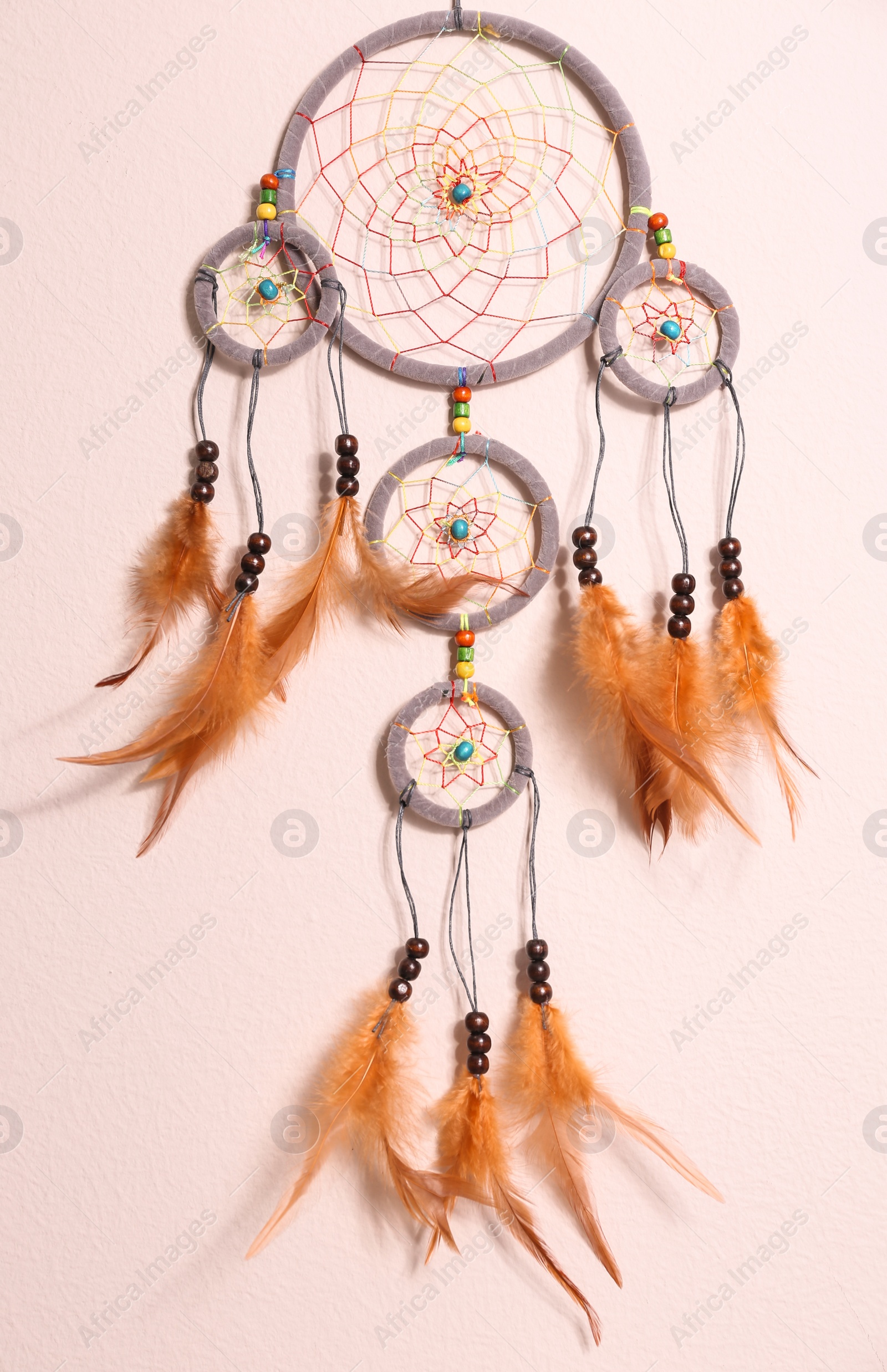 Photo of Beautiful handmade dream catcher on beige wall