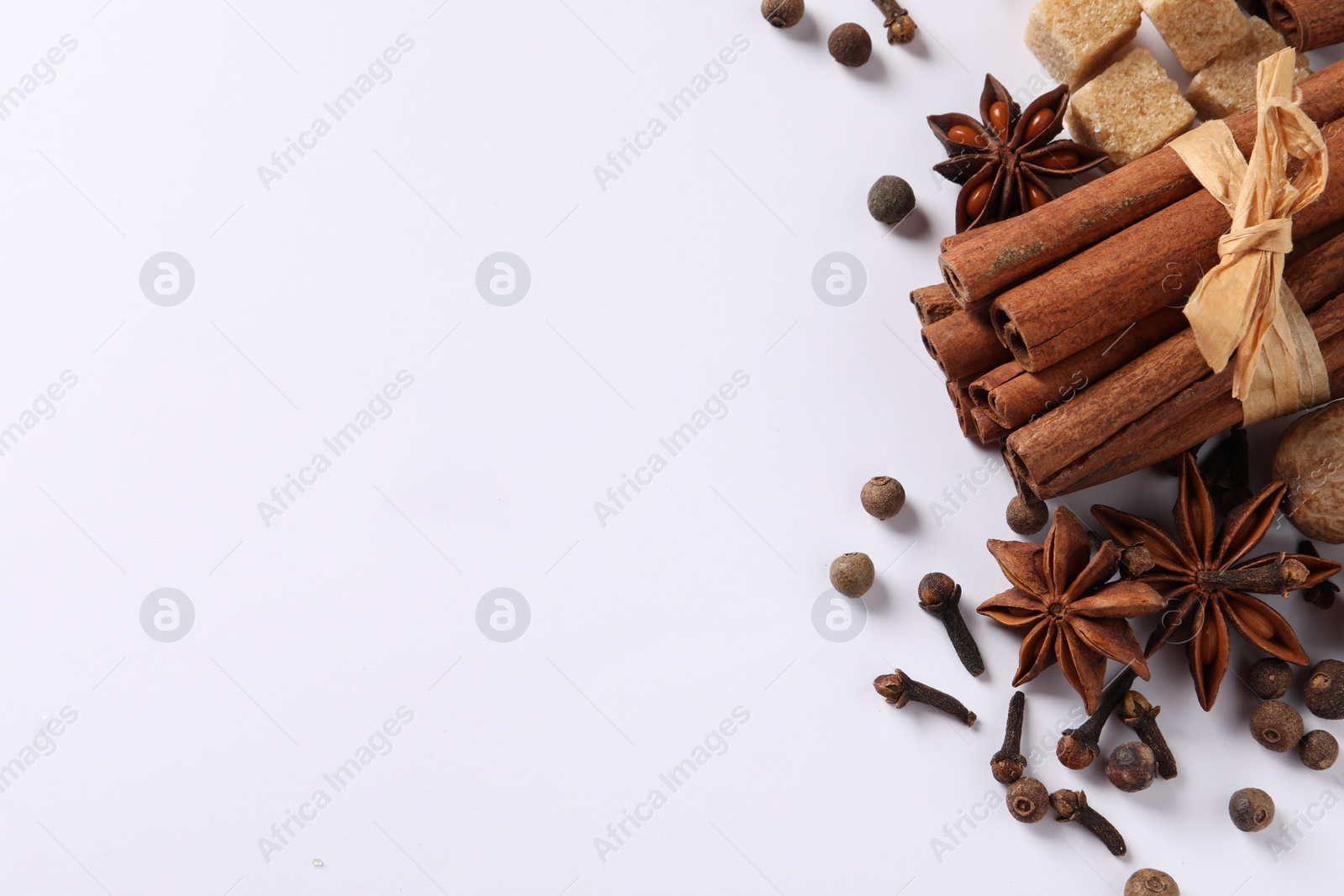 Photo of Different spices on white table, flat lay. Space for text