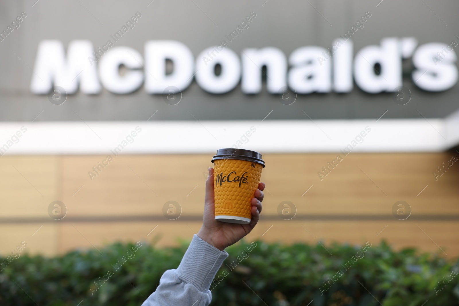 Photo of Lviv, Ukraine - September 26, 2023: Woman with hot McDonald's drink outdoors, closeup