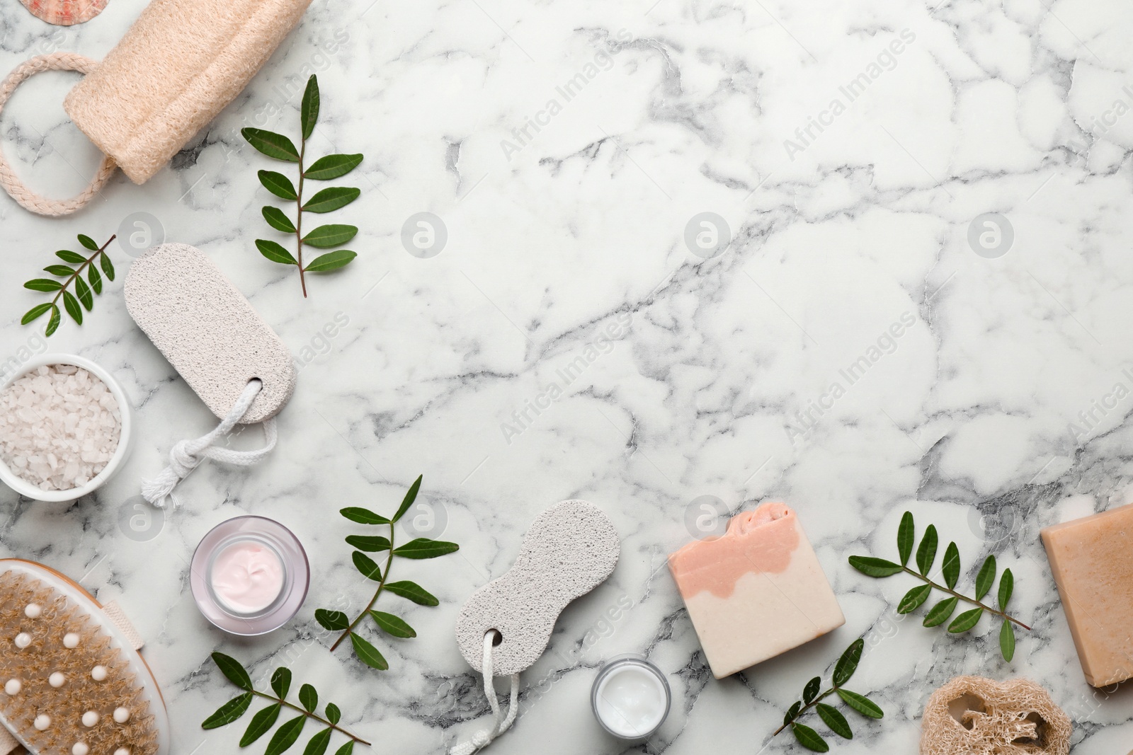 Photo of Flat lay composition with pumice stones on white marble background. Space for text