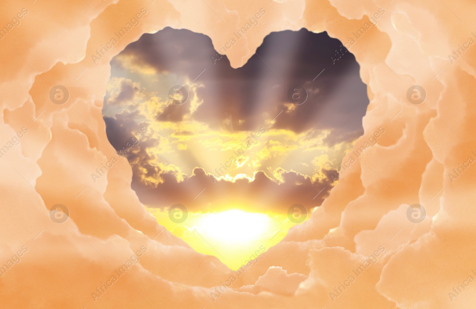 Image of Beautiful sunset. Sky with shining sun, view through heart shaped gap formed from clouds