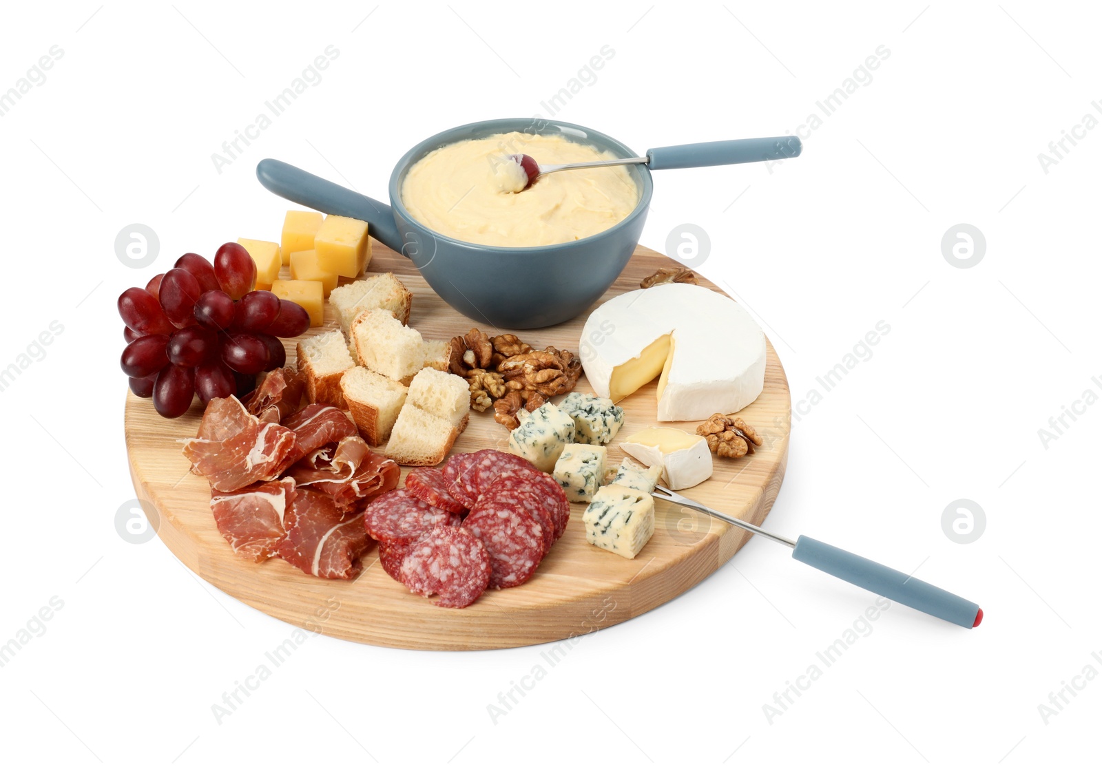 Photo of Fondue with tasty melted cheese, forks and different snacks isolated on white