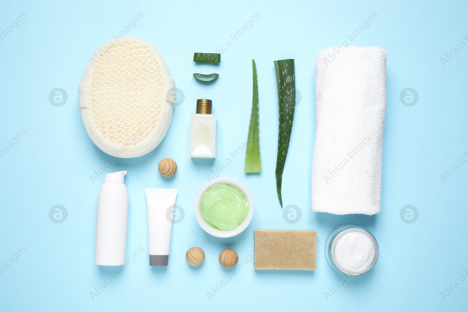 Photo of Flat lay composition with aloe vera and cosmetic products on light blue background