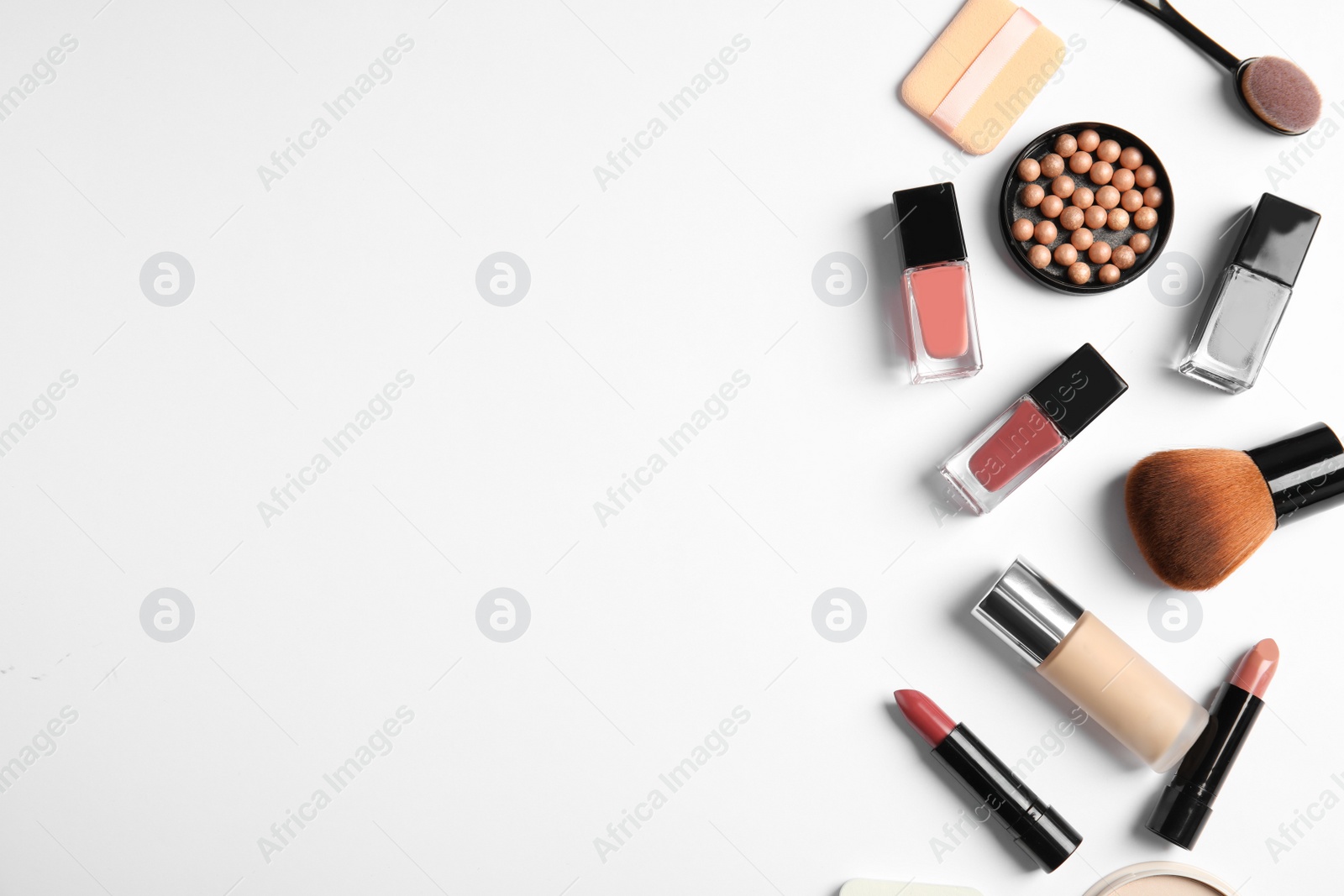 Photo of Flat lay composition with bottles of nail polish and different cosmetics on white background