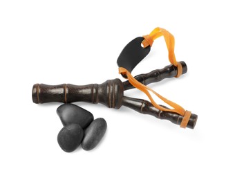 Photo of Black wooden slingshot with stones on white background