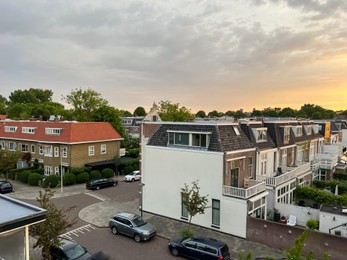 Picturesque view of city street with beautiful buildings at sunrise