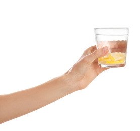 Photo of Young woman with glass of lemon water on white background, closeup