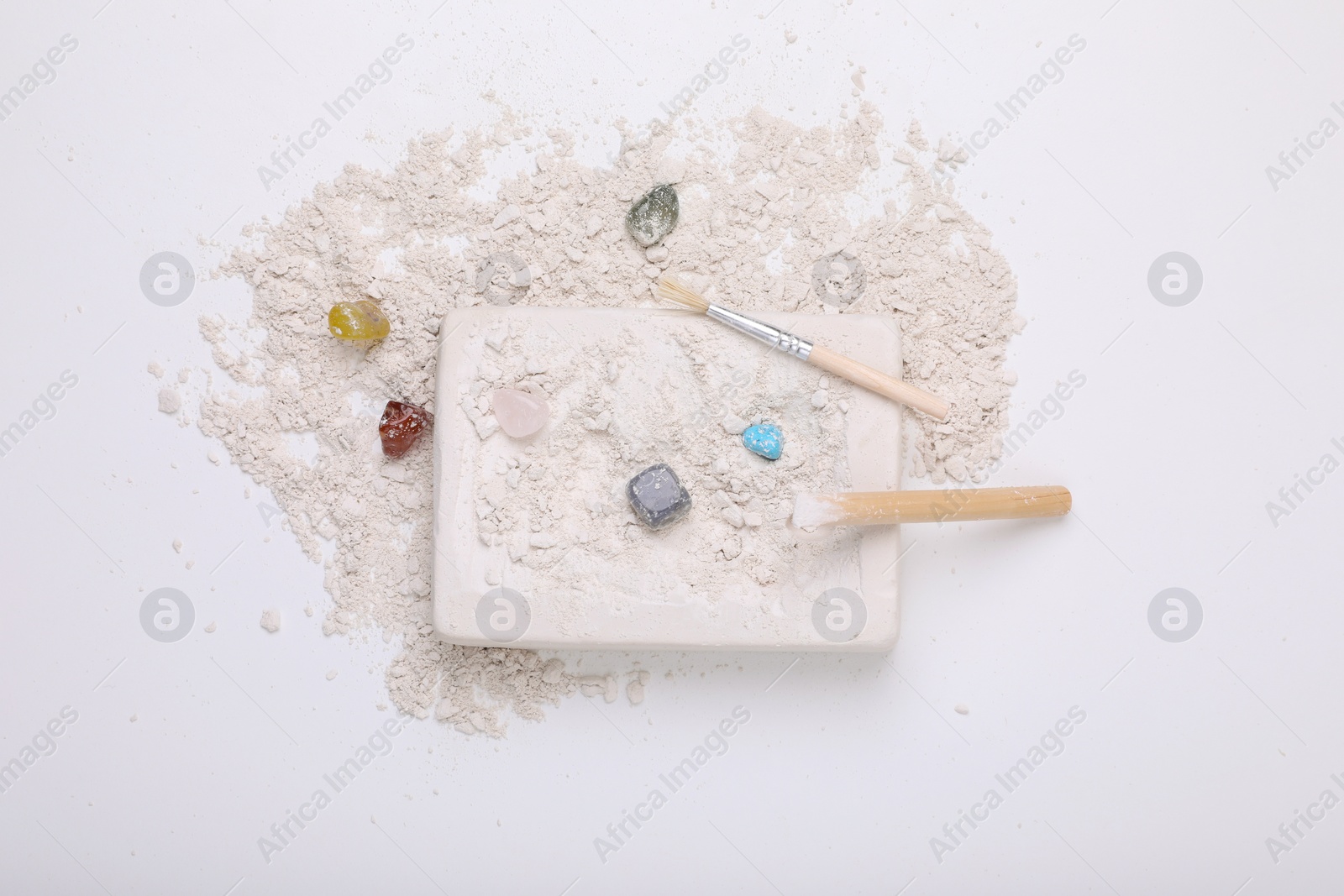 Photo of Excavation kit on white background, top view. Educational toy for motor skills