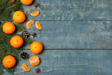 Photo of Flat lay composition with tangerines on blue wooden background. Space for text