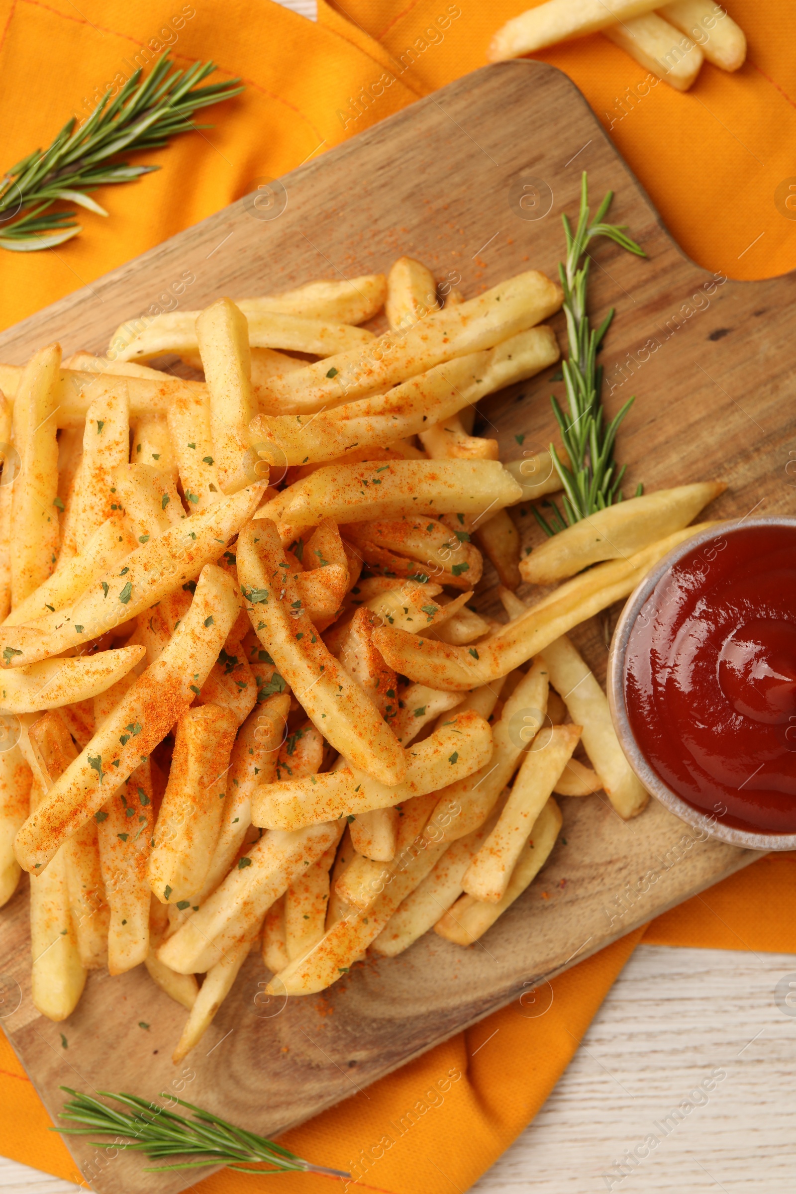 Photo of Delicious french fries served with sauce on white wooden table, flat lay