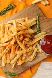 Delicious french fries served with sauce on white wooden table, flat lay