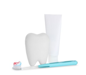 Photo of Tooth shaped holder, paste and brush on white background