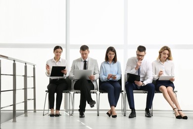 Photo of People waiting for job interview in office hall