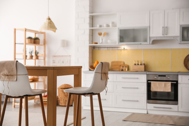 Modern kitchen interior with stylish wooden table