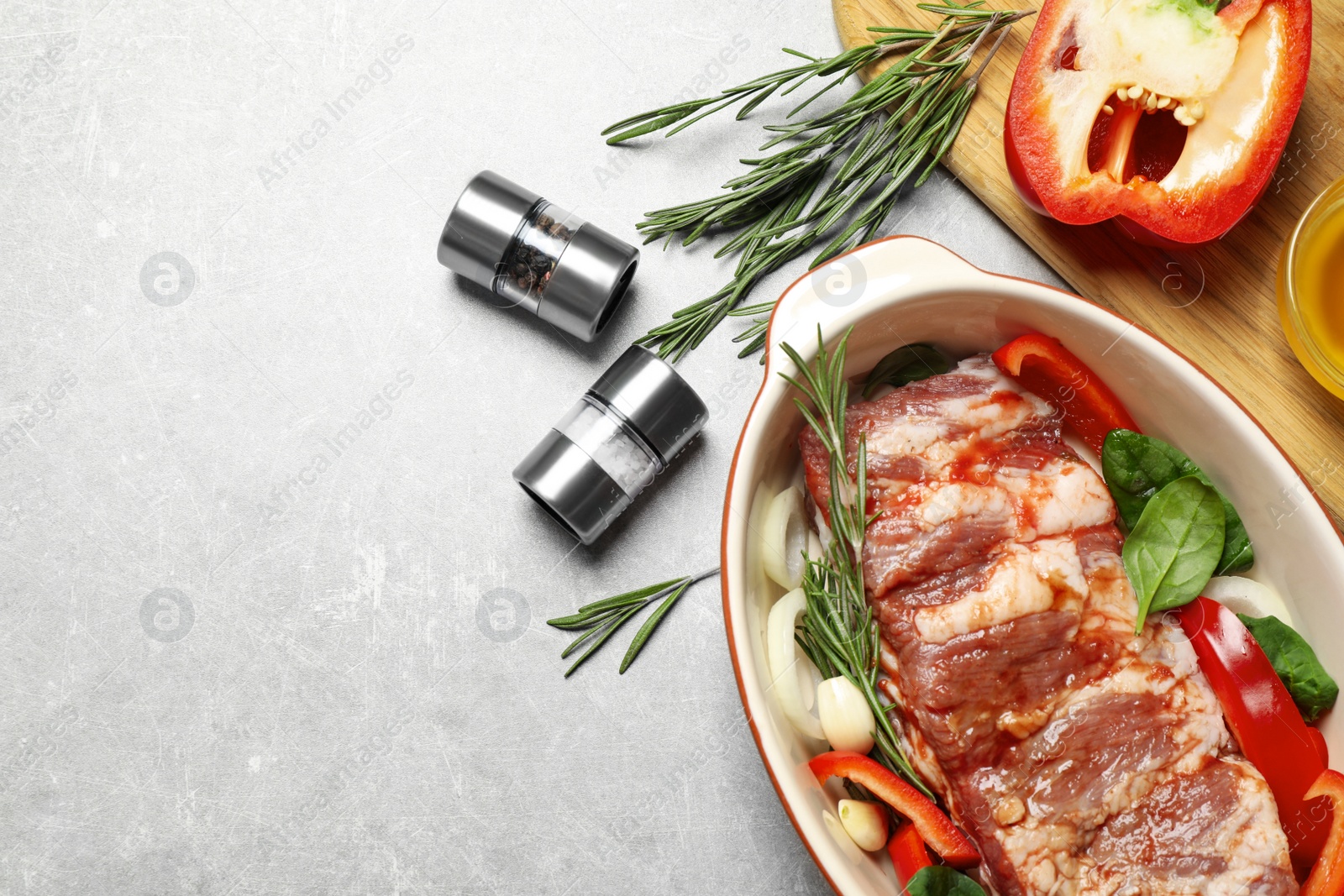 Photo of Raw spare ribs with garnish on light table, flat lay. Space for text